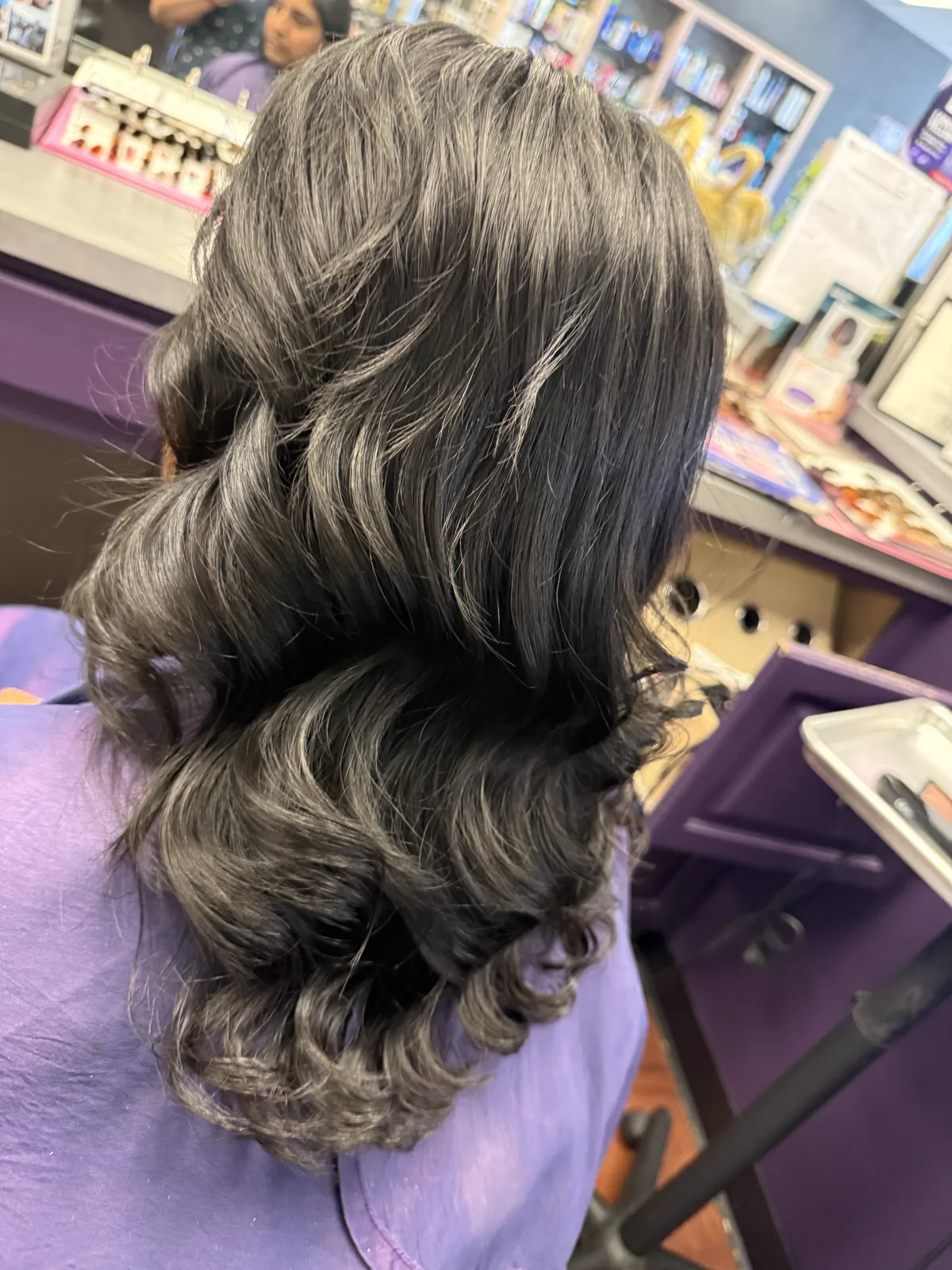 Glossy curled hair after a salon color and styling service